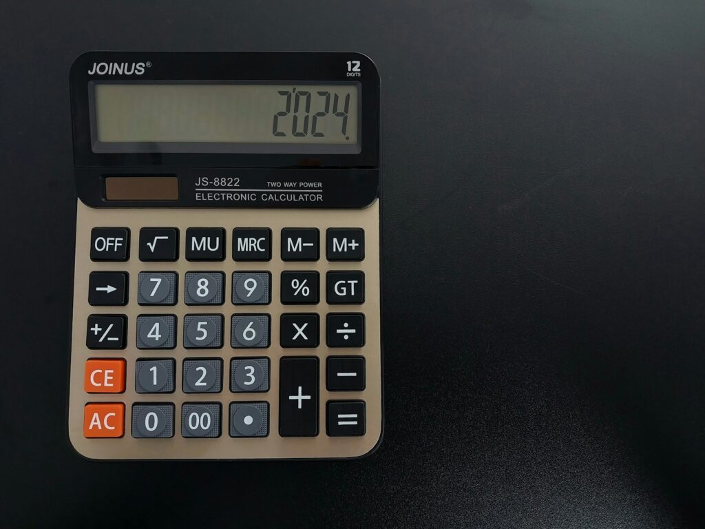 a calculator sitting on top of a table with decimal numbers.
