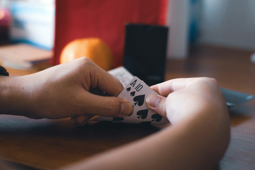 A person holding a set of blackjack cards.