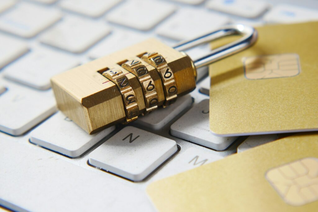 a golden encryption padlock sitting on top of a keyboard